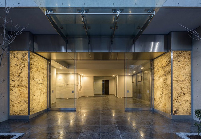Backlit stone entrance walls illuminated by flexible LED light sheets